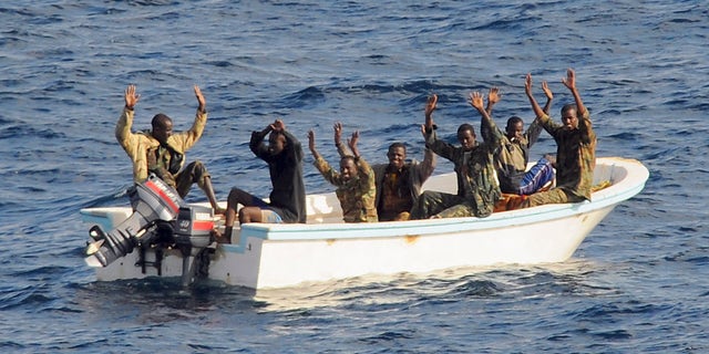February 11, 2009: Suspected pirates keep their hands in the air as directed by sailors aboard the guided-missile cruiser USS Vella Gulf (CG 72) (not shown), in the Gulf of Aden.