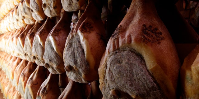 A line of hams hang to dry. (Reuters)