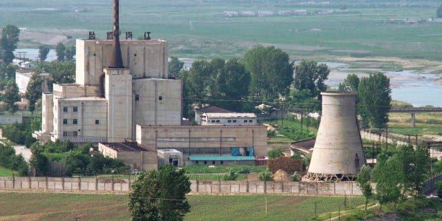 A North Korean nuclear plant is seen before demolishing a cooling tower (R) in Yongbyon.