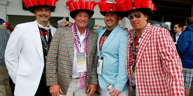 Attendees wear matching elaborate hats before the running of the 139th Kentucky Derby horse race at Churchill Downs.