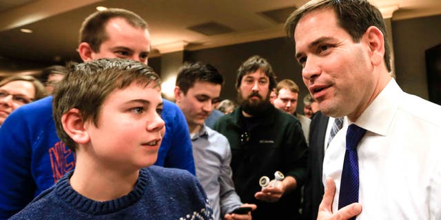Rubio talks to members of the audience following a campaign stop in Iowa, Sat. Jan. 16, 2016.