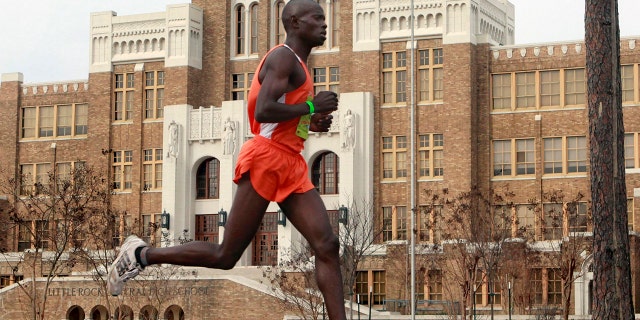 In this March 7, 2010, file photo, Moninda Marube runs past Little Rock Central High during the Little Rock Marathon race in Little Rock, Ark.
