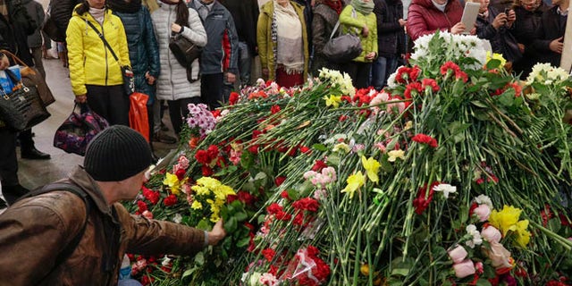 People gather at a symbolic memorial at Technologicheskiy Institute subway station in St.Petersburg, Russia, Friday, April 7, 2017. A bomb blast tore through a subway train under Russia's second-largest city on Monday, killing people and wounding more than 40. (AP Photo/Dmitri Lovetsky)