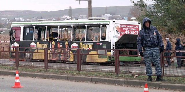 Oct. 22, 2013: In this image made from video, experts and officials examine a wreckage of a bus in Volgograd, Russia. A female suicide bomber blew herself up on the city bus in southern Russia on Monday, killing six people and injuring about 30, officials said. The attack in Volgograd added to security fears ahead of the Winter Olympics in Sochi.