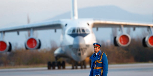 Serbian army officer walks in front of Soviet made heavy cargo plane Ilyushin Il-76 on the tarmac at the Constantine the Great Airport, near a "Russian-Serbian Humanitarian Center" in Serbia.