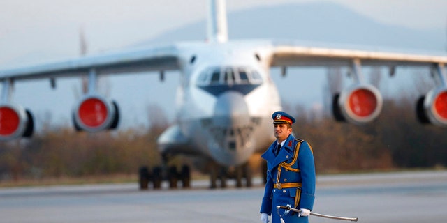 Serbian army officer walks in front of Soviet made heavy cargo plane Ilyushin Il-76 on the tarmac at the Constantine the Great Airport, near a "Russian-Serbian Humanitarian Center" in Serbia.