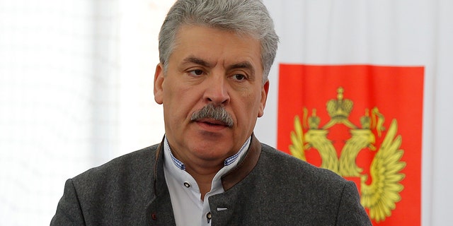 Communist party candidate Pavel Grudinin prepares to cast his ballot in the presidential election at the Lenin state farm outside Moscow, March 18, 2018.