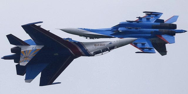 August 1, 2015: Sukhoi Su-27 fighters of the Russian Knights aerobatic display team perform during a demonstration flight at an opening ceremony of the International Army Games-2015 in Alabino, outside Moscow, Russia.