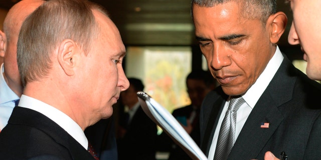 FILE -- Nov. 11, 2014: Russian President Vladimir Putin, left, and President Barack Obama, talk on the sidelines of the Asia-Pacific Economic Cooperation (APEC) Summit in Beijing. (AP)