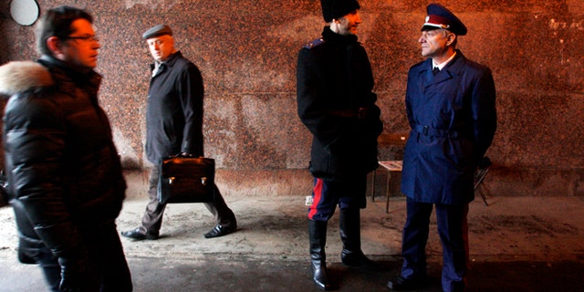 Nov. 27, 2012: Two Russian Cossacks, right, watch pedestrians passing by as they patrol Belorussky railway station in downtown Moscow, Russia.