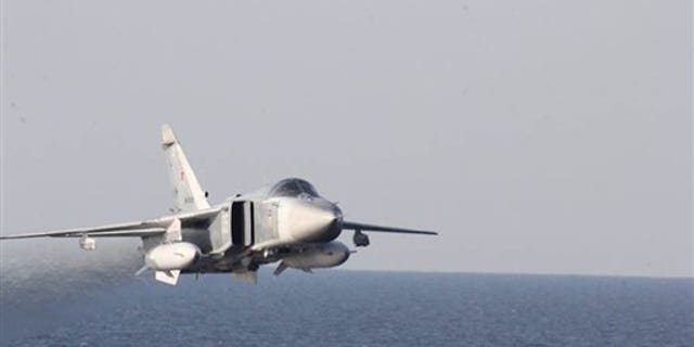 A Russian fighter jet makes a low altitude pass by the USS Donald Cook on April 12.