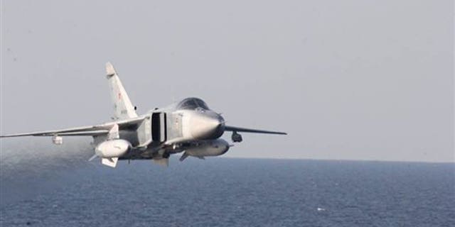 A Russian fighter jet makes a low altitude pass by the USS Donald Cook on April 12.