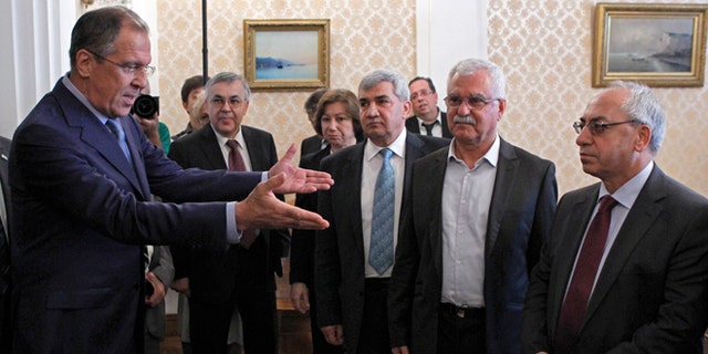 July 11, 2012: Russian Foreign Minister Sergey Lavrov, left, welcomes a delegation headed by a leader of the Syrian National Council (SNC), Abdulbaset Sieda, right, in Moscow, Russia.