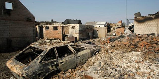 A charred car stands in the village Shuberskoe destroyed by a forest fire near the town of Voronezh, some 500 km (294 miles) south of Moscow, Russia, Monday, Aug. 2, 2010. At least 34 people have died in wildfires that have destroyed hundreds of homes and burned through vast spans of tinder-dry land, but firefighters are making headway and the blazes are dying down.