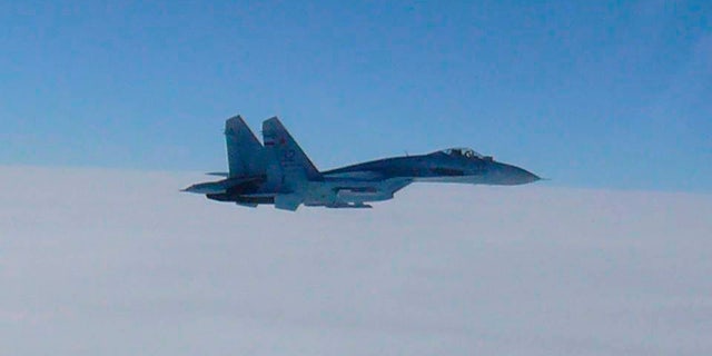 A Russian Su-27 fighter, as seen in this handout photo, buzzed a US drone over the Black Sea on Tuesday.