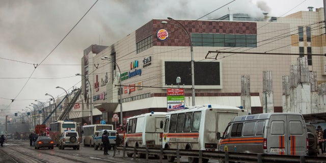 Smoke rises above a multi-story shopping center in the Siberian city of Kemerovo, about 1,900 miles east of Moscow, Russia, on Sunday, March 25, 2018.
