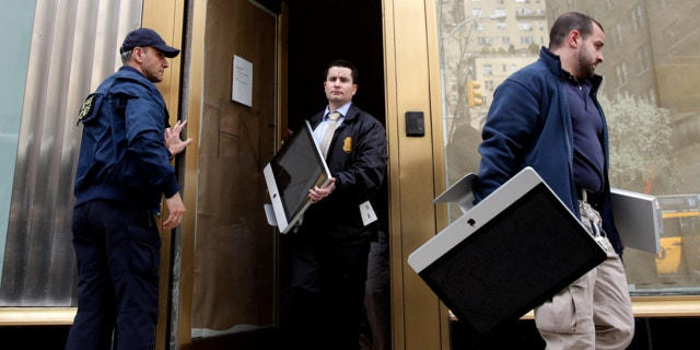 April 16, 2013: Federal agents remove items, including computers, from an art gallery in New York.