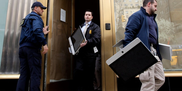 April 16, 2013: Federal agents remove items, including computers, from an art gallery in New York.