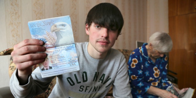 March 20, 2013: Alexander Abnosov shows his American passport to journalists in the Volga river city of Cheboksary, Russia.