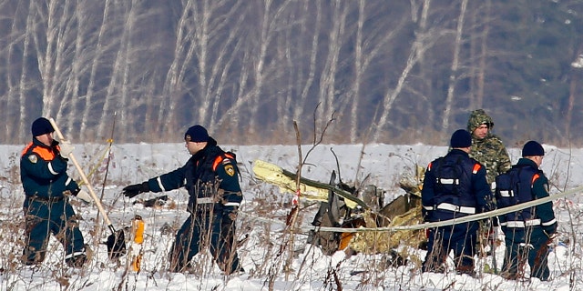 Personnel work at the scene of the AN-148 plane crash in Stepanovskoye village.
