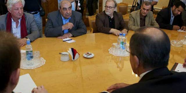 July 9, 2012: Michel Kilo, a Syrian opposition leader and writer, second left, and other unidentified members of a delegation meet with Russian Foreign minister Sergey Lavrov, foreground right, in Moscow, Russia.