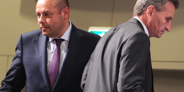 June 11, 2014: European Commissioner for Energy Guenther Oettinger walks past Ukraine Energy Minister Yuriy Prodan as he addresses the media at the European Commission headquarters in Brussels. (AP)