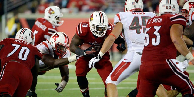 Oct 10, 2013;Louisville Cardinals running back Dominique Brown (10) runs the ball against Rutgers Scarlet Knights linebacker Kevin Snyder (45) during the second half at Papa John's Cardinal Stadium.