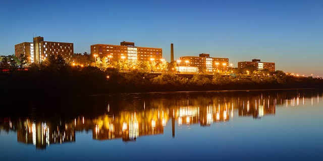 Night view of the Rutgers University campus Halls reflecting on a calm Raritan River