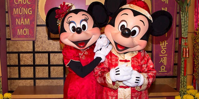 This January 2016 image provided by Disneyland Resort shows Mickey Mouse and Minnie Mouse dressed in red for a Lunar New Year celebration at Disney California Adventure Park in Anaheim, Calif. The park will celebrate year of the rooster this year from Jan. 20 through Feb. 5 with live performances, activities, decor, special food and Disney characters dressed for the Lunar New Year holiday. (Disneyland Resort via AP)
