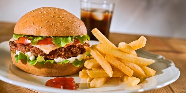 cheeseburger french rries and coke on a plate