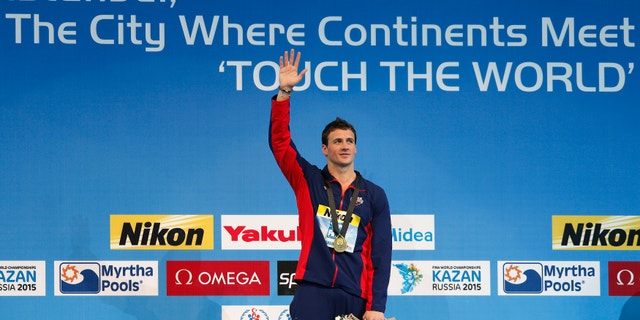 Gold medallist Ryan Lochte of the U.S. celebrates during the award ceremony for the men's 200m individual medley final during the FINA World Swimming Championships in Istanbul December 14, 2012.