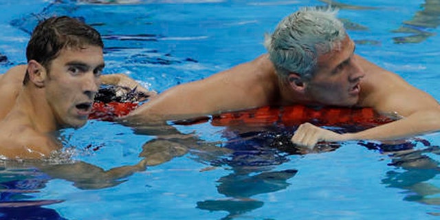 United States' Michael Phelps wins the gold medal in the men's 200-meter individual medley ahead of fifth placed United States' Ryan Lochte, right, during the swimming competitions at the 2016 Summer Olympics, Thursday, Aug. 11, 2016, in Rio de Janeiro, Brazil. (AP Photo/Natacha Pisarenko)