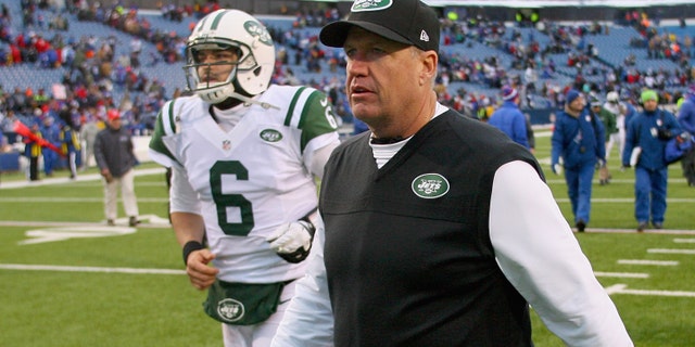 Head coach Rex Ryan and Mark Sanchez #6 of the New York Jets walk off the field after losing to the Buffalo Bills 28-9 at Ralph Wilson Stadium on December 30, 2012 in Orchard Park, New York.