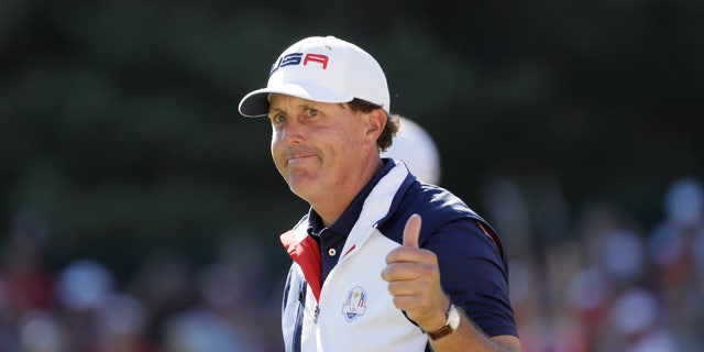 Phil Mickelson gives a thumbs up after playing the 15th hole during a singles match at the Ryder Cup tournament.