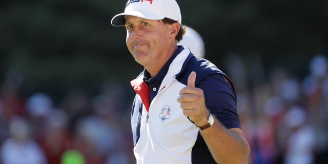 Phil Mickelson gives a thumbs up after playing the 15th hole during a singles match at the Ryder Cup tournament.