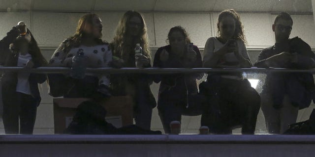 Students watch from a balcony during a demonstration calling for lower tuition at Hunter College in New York