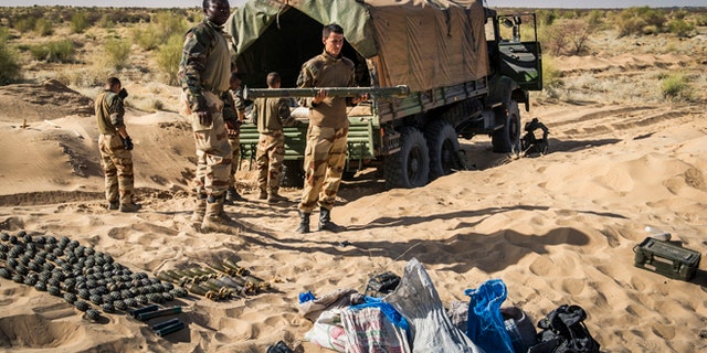 In this March 29, 2013 photo provided by the French Army's images division, ECPAD, a French soldier holds the launch tube of an SA-7 surface-to-air missile before its destruction in Timbuktu, northern Mali. The knowledge that the terrorists have the weapon has already changed the way the French are carrying out their five-month-old offensive in Mali. They are using more fighter jets rather than helicopters to fly above its range of 1.4 miles from the ground, even though that makes it harder to attack the jihadists. They are also making cargo planes land and take off more steeply to limit how long they are exposed, in line with similar practices in Iraq after an SA-14 hit the wing of a DHL cargo plane in 2003.