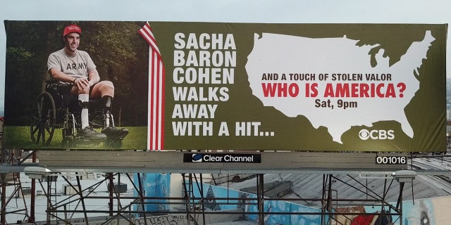 Street artist Sabo has posted a billboard that accuses Sacha Baron Cohen of stolen valor.
