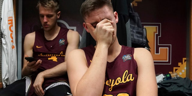 Loyola-Chicago's Carson Shanks (32) cries in the locker room after the semifinal game against Michigan.