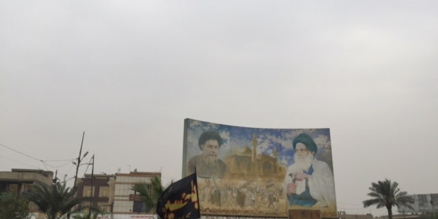 Billboard of Iraqi Shia clerics Moqtada Sadr and Allyatollah Ali Sistani