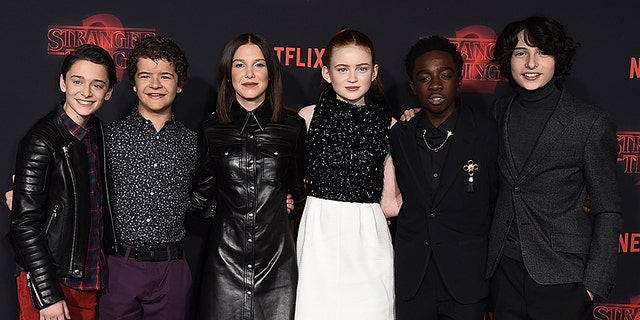 Noah Schnapp, from left, Gaten Matarazzo, Millie Bobby Brown, Sadie Sink, Caleb McLaughlin and Finn Wolfhard arrive at the premiere of "Stranger Things" Season 2 