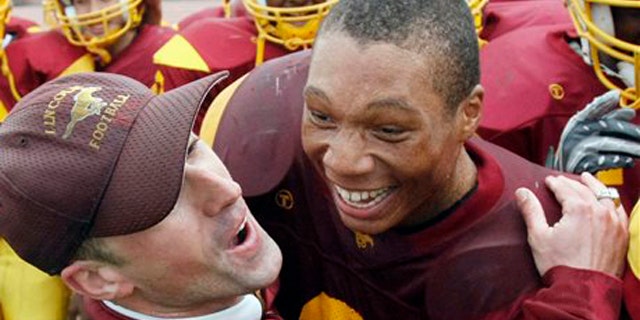 In this file photo taken Nov. 27, 2008, Lincoln Assistant Coach Kevin Doherty, left, hugs running back DeShon Marman as Lincoln defeated Washington in the annual Academic Athletic Association (AAA), San Francisco championship high school football game in San Francisco.