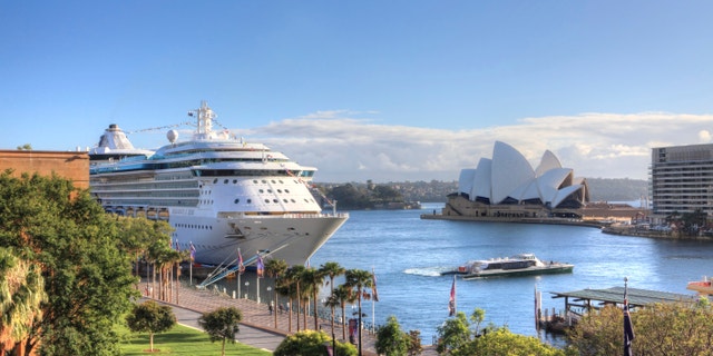 Sydney, Australia - December 1, 2013; Royal Carribean Cruise Liner, Radiance of the Seas docked at Circular Quay in Sydney. Sydney Opera House in background. This ship boasts floor to ceiling windows and an outdoor cinema playing first run movies.