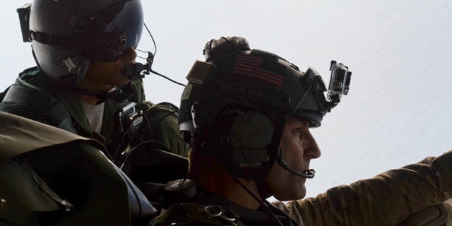 May 3, 2014: Airman 1st Class Franscisco Harper, left, and a pararescue airman survey the area as U.S. Air Force pararescue forces parachute into the Pacific Ocean to aid to two critically injured sailors aboard a Venezuelan fishing boat.