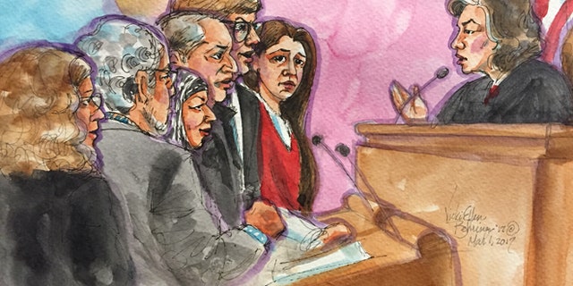 Noor Salman, seen wearing red, with relatives and attorneys.