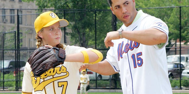Then-New York Mets outfielder Carlos Beltran (R) coaches Sammi Kane Kraft, star of the film "Bad News Bears", during a promotional event in Harlem, New York, July 19, 2005.