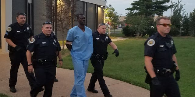Police taking Samson, center, to jail.