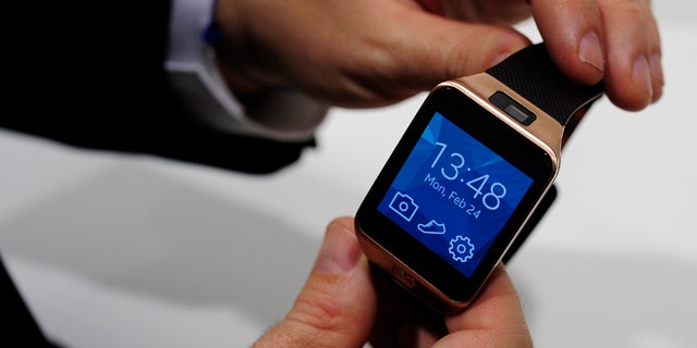 Samsung Gear 2, one of two new computerized wristwatches, this time including health sensors and related fitness features to give people a reason to buy one, is displayed at the Mobile World Congress in Spain.