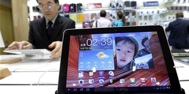 Oct. 7, 2011: A man uses Samsung Electronics' tablet Galaxy Tab 10.1 displayed for customers at the company's headquarters in Seoul.