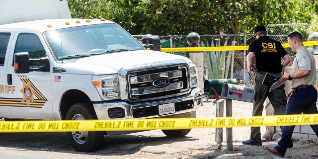 San Bernardino County Sheriff's personnel investigate the scene of a fatal shooting in Muscoy, Calif., on Friday.